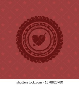 heart with arrow icon inside badge with red background