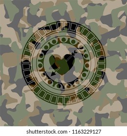 heart with arrow icon inside camouflaged emblem