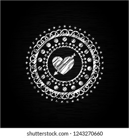 heart with arrow icon inside chalkboard emblem written on a blackboard