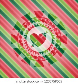 heart with arrow icon inside christmas emblem.