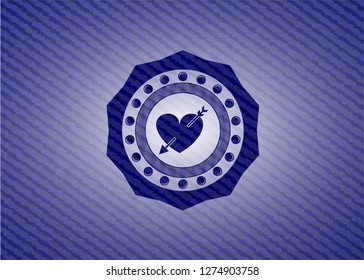 heart with arrow icon inside denim background