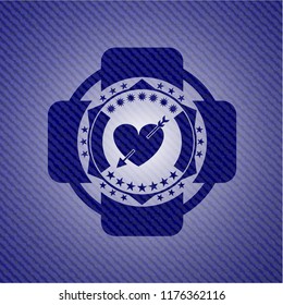 heart with arrow icon inside emblem with jean texture