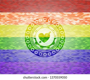heart with arrow icon inside emblem on mosaic background with the colors of the LGBT flag