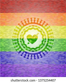 heart with arrow icon inside emblem on mosaic background with the colors of the LGBT flag