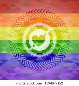 heart with arrow icon inside emblem on mosaic background with the colors of the LGBT flag