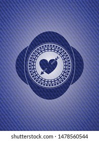 heart with arrow icon inside emblem with jean background
