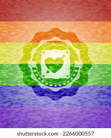 heart with arrow icon inside emblem on mosaic background with the colors of the LGBT flag. 