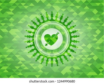 heart with arrow icon inside green emblem with triangle mosaic background