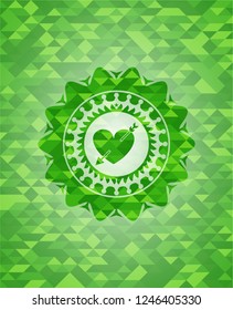heart with arrow icon inside green emblem with mosaic ecological style background