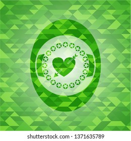 heart with arrow icon inside green emblem with triangle mosaic background
