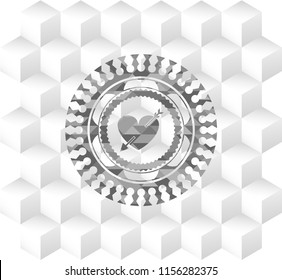 heart with arrow icon inside grey icon or emblem with geometric cube white background