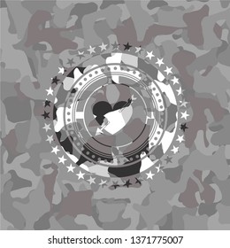 heart with arrow icon inside grey camo emblem
