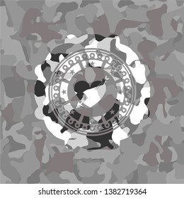 heart with arrow icon inside grey camouflage emblem
