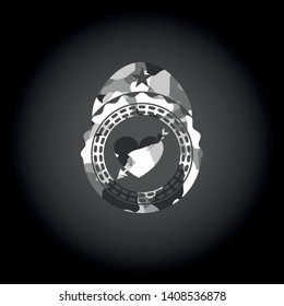 heart with arrow icon inside grey camo emblem