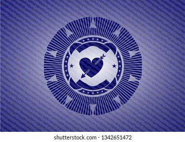 heart with arrow icon inside jean background
