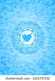 heart with arrow icon inside light blue emblem. Mosaic background