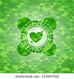 heart with arrow icon inside realistic green emblem. Mosaic background