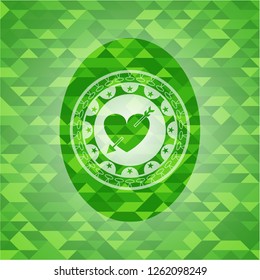 heart with arrow icon inside realistic green emblem. Mosaic background