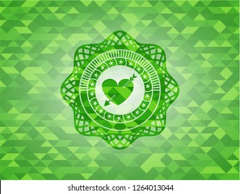 heart with arrow icon inside realistic green emblem. Mosaic background