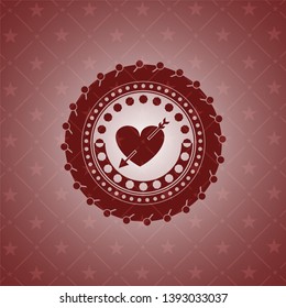 heart with arrow icon inside red emblem