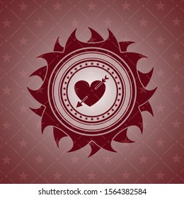 heart with arrow icon inside red emblem
