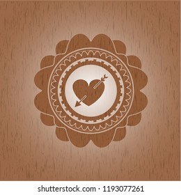 heart with arrow icon inside retro wooden emblem