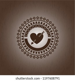 heart with arrow icon inside retro wood emblem