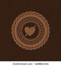 heart with arrow icon inside retro wooden emblem