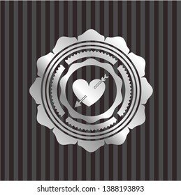 heart with arrow icon inside silver emblem or badge
