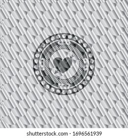 heart with arrow icon inside silver color emblem. Scales pattern. Vector Illustration. Detailed.