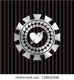 heart with arrow icon inside silvery emblem or badge