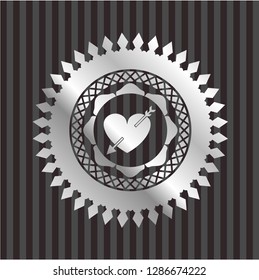 heart with arrow icon inside silvery emblem or badge