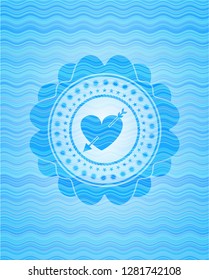 heart with arrow icon inside sky blue water wave style badge.