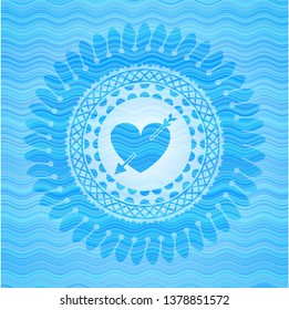 heart with arrow icon inside sky blue water wave emblem background.