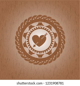 heart with arrow icon inside vintage wood emblem