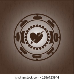 heart with arrow icon inside vintage wood emblem
