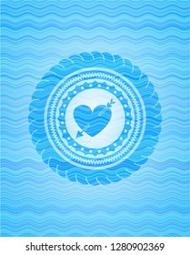 heart with arrow icon inside water wave badge.