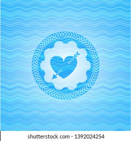 heart with arrow icon inside water concept emblem.