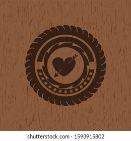 heart with arrow icon inside wood emblem. Retro