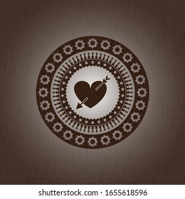 heart with arrow icon inside wood badge or emblem