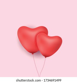 heart balloon red both on pink background.