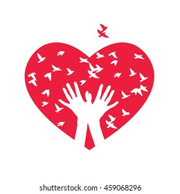 The heart of the birds. silhouette of two hands producing birds on a background of red hearts