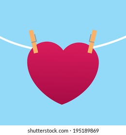 Heart clipped to string with blue background 