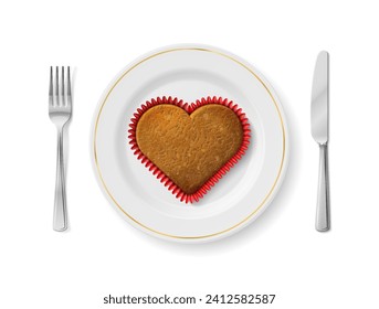 Heart cupcake is on white plate with fork and knife, top view. Dinner plate with heart shaped cookie inside and cutlery set on sides