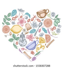 Heart design with pastel cinnamon, lemons, oranges, tea bag, sugar cubes, heather, chamomile, dog rose, peppermint, almond, strawberry, teaspoon, teapots, cups, sugar bowl