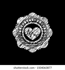 heart with electrocardiogram icon drawn on a blackboard