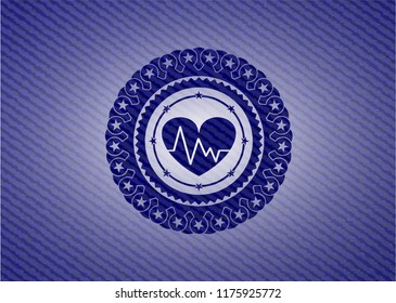 heart with electrocardiogram icon inside badge with denim background