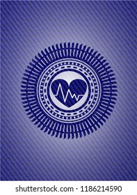 heart with electrocardiogram icon inside badge with jean texture