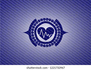 heart with electrocardiogram icon inside badge with jean texture
