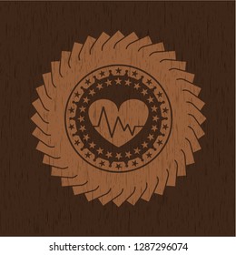 heart with electrocardiogram icon inside badge with wood background